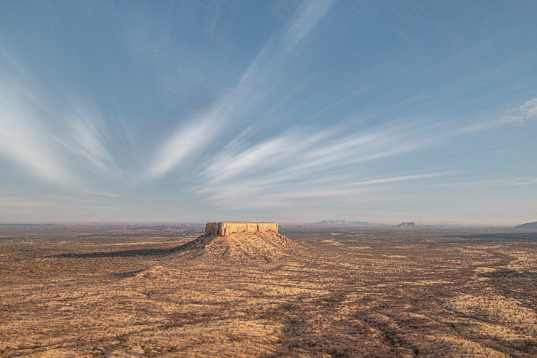 Wüstenlandschaft von Damaraland mit einem einsamen Felsen in der Mitte, Namibia, Afrika