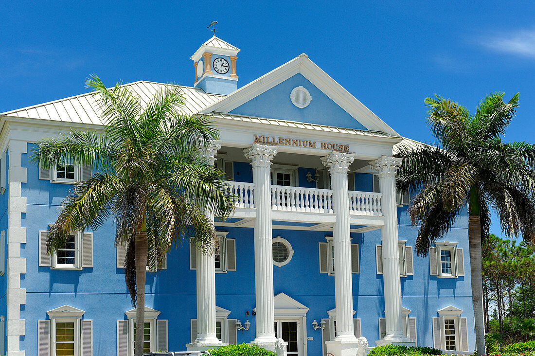 Bahamas, Grand Bahama Island, Freeport, official colonial style building painted blue with columns in the center of the capital 