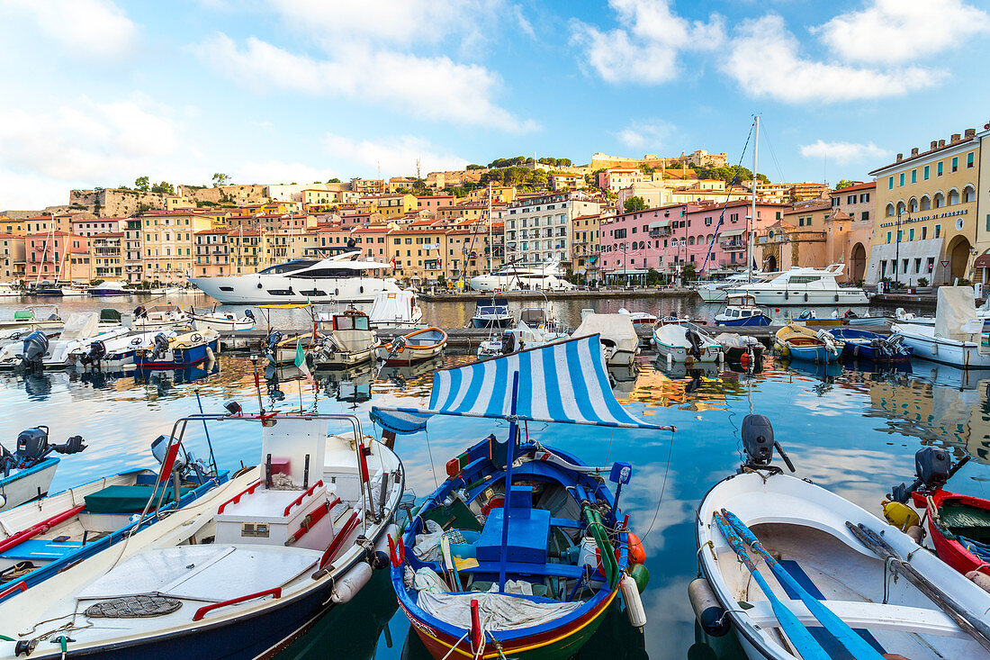 Harbour of Portoferraio, boats moored close together and buildings on the hillside