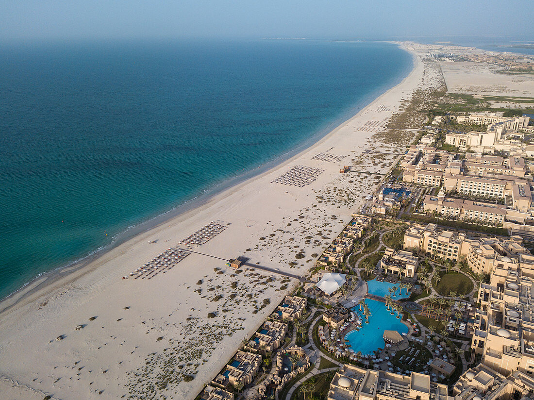 Aerial of Saadiyat Rotana Resort & Villas (front) and other beachfront hotels with beach and sea, Saadiyat Island, Abu Dhabi, United Arab Emirates, Middle East