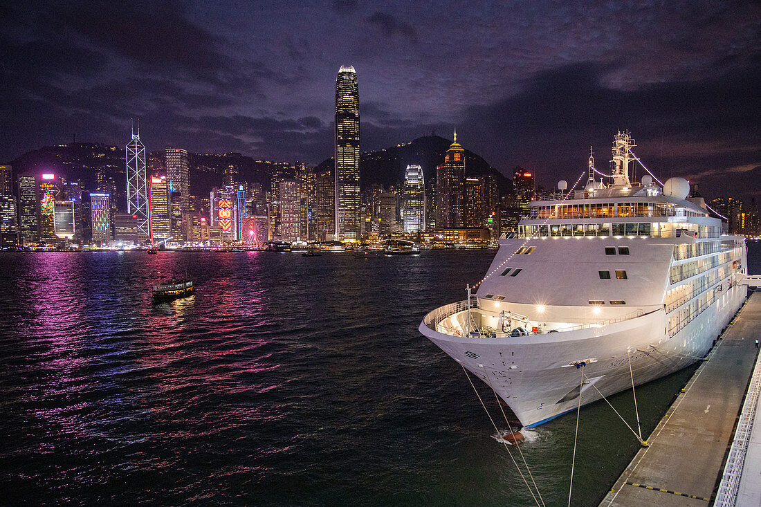 Cruise ship Silver Shadow at the Hong Kong Cruise Terminal with city skyline at dusk, Hong Kong, Hong Kong, China, Asia