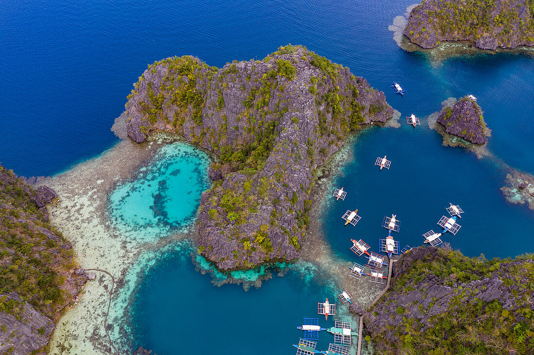 Aerial view of traditional Filipino Banca outrigger canoes lying in the lagoon near Lake Kayangan, Banuang Daan, Coron, Palawan, Philippines, Asia