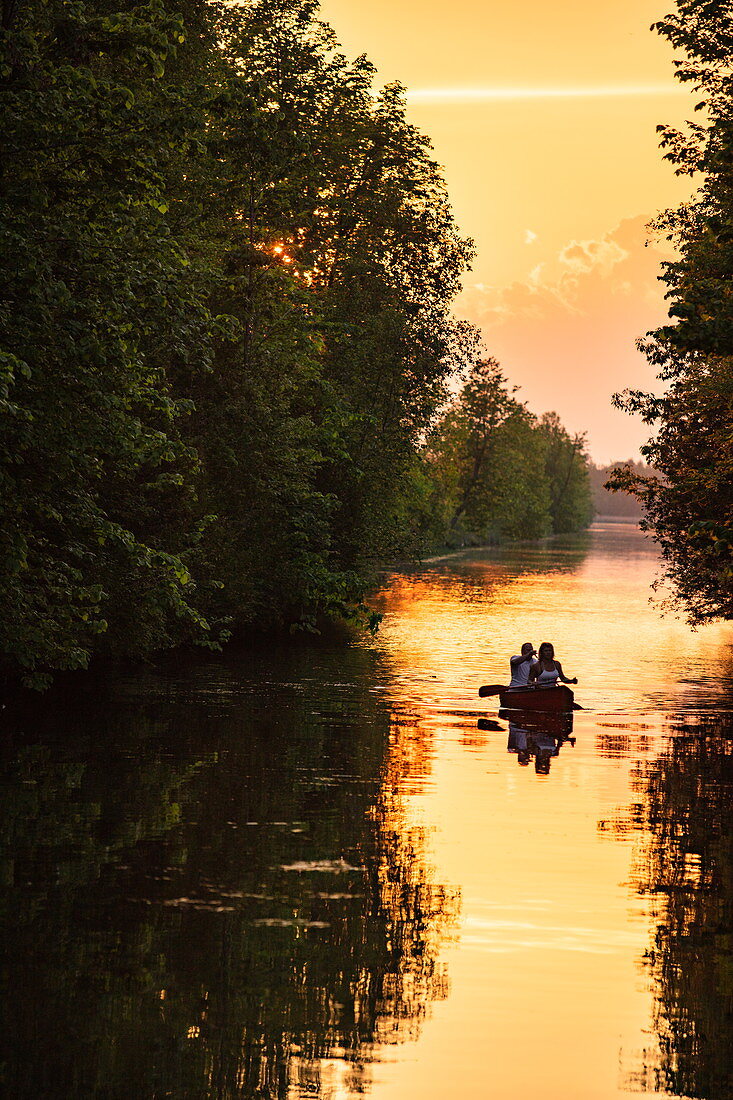 Couple paddling canoe near Beveridge Locks locks on the Tay River at sunset, near Lower Rideau Lake, Ontario, Canada, North America