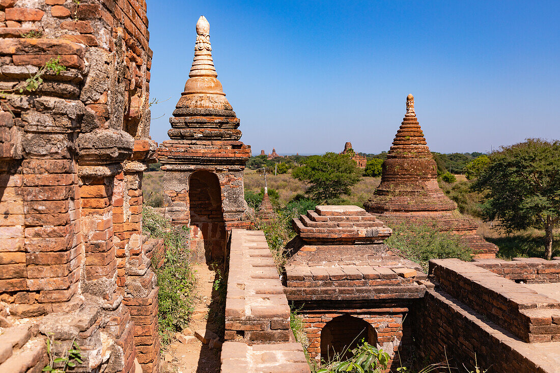 Individual stupas decorate a building of the historical temple complex of Bagan in Myanmar