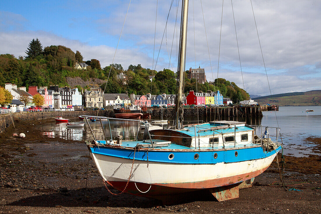 Sailboat and colorful house facades in Tobermory, Mull, Inner Hebrides, Scotland UK