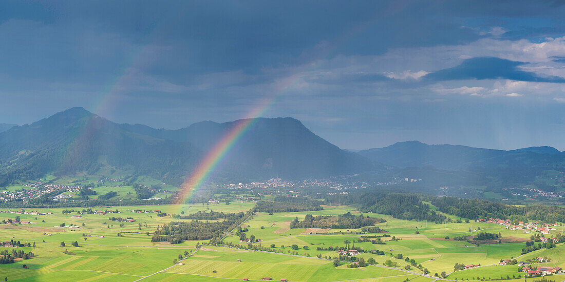 Panorama from Grünten over the Illertal with rainbow to Blaichach and Immenstadt, behind it Steineberg, 1660m and Mittagberg, 1451m, Allgäu Alps, Allgäu, Bavaria, Germany, Europe