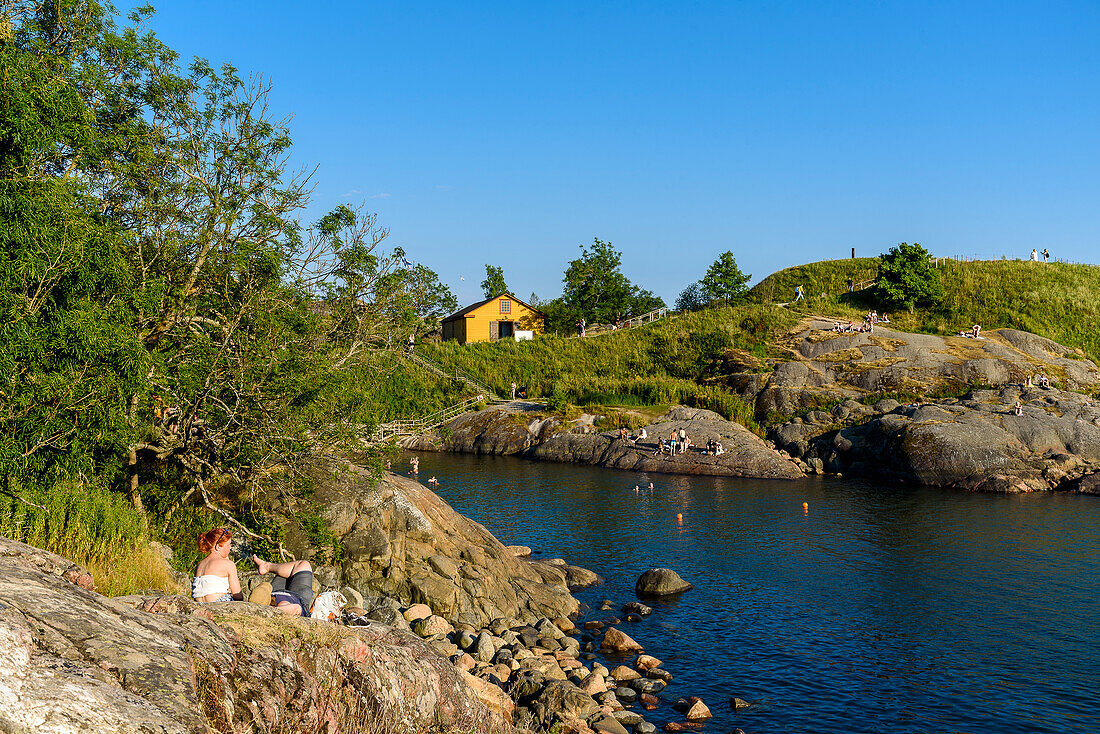 Suomenlinna fortress island, people picnicking and bathing, Helsinki, Finland