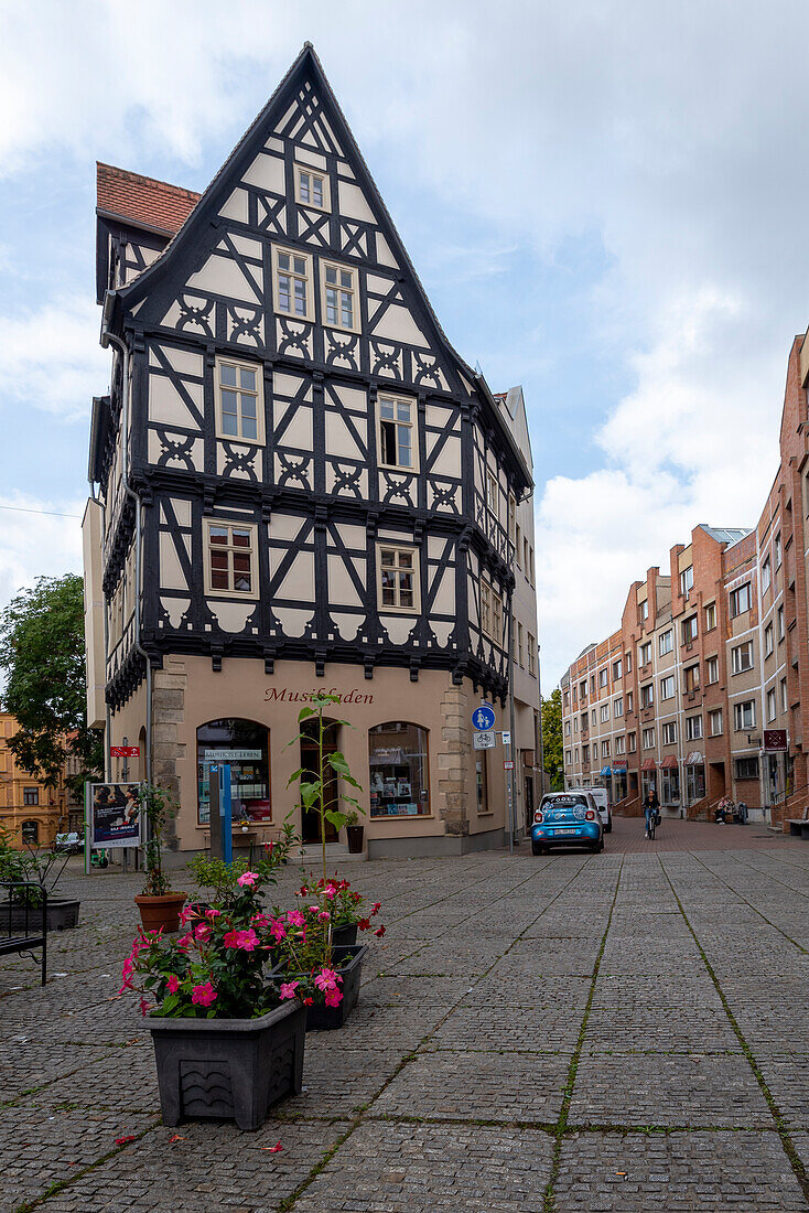 Historic half-timbered house, next to it redesigned prefabricated buildings, Grasweg, Halle an der Saale, Saxony-Anhalt, Germany