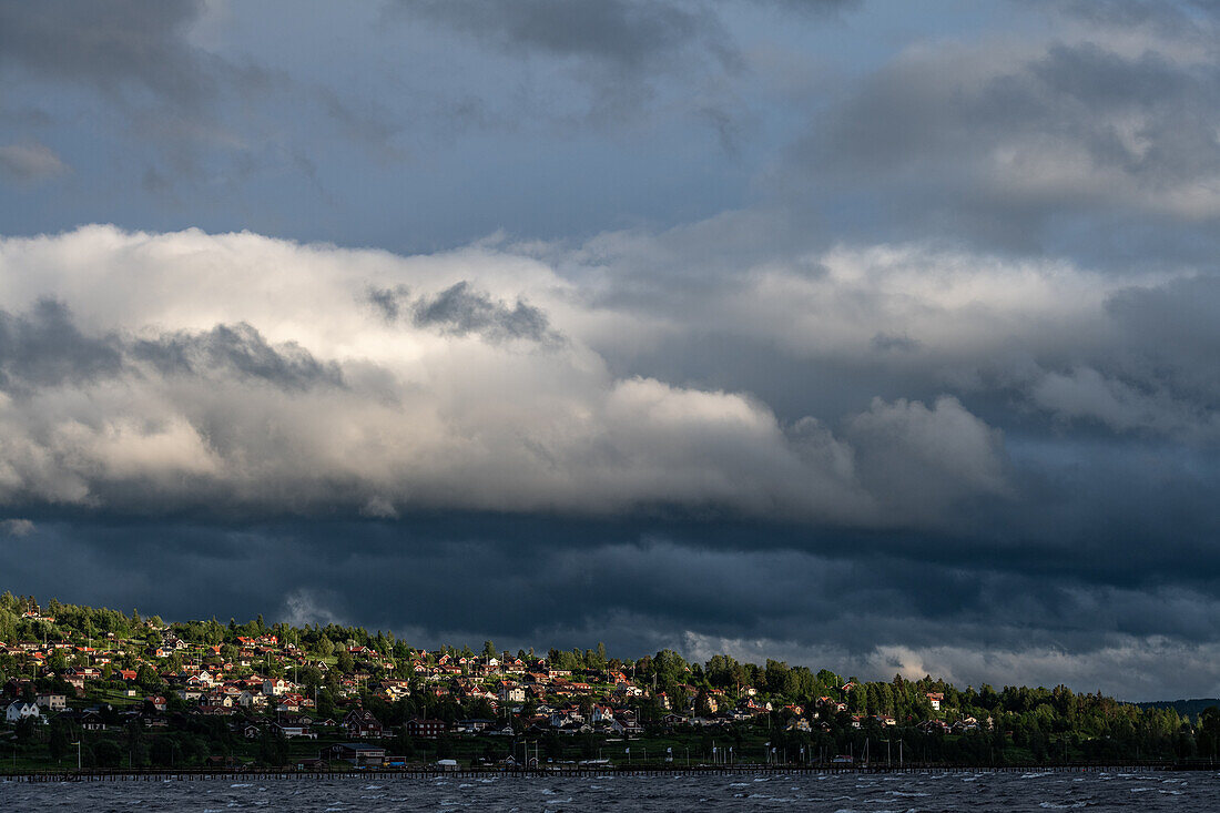 Dark clouds over the houses on the banks of Lake Siljan, Rättvik, Dalarna, Sweden