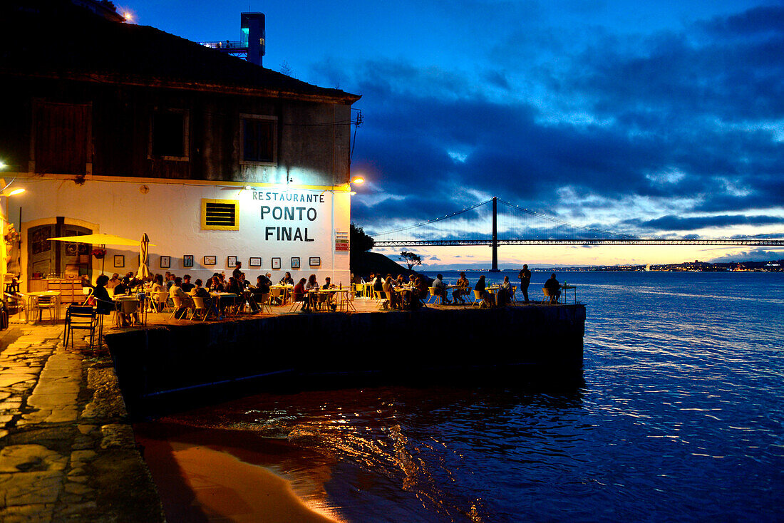 View from Almada on the south side of the Tagus River with bridge and restaurant Ponte Final, Lisbon, Portugal