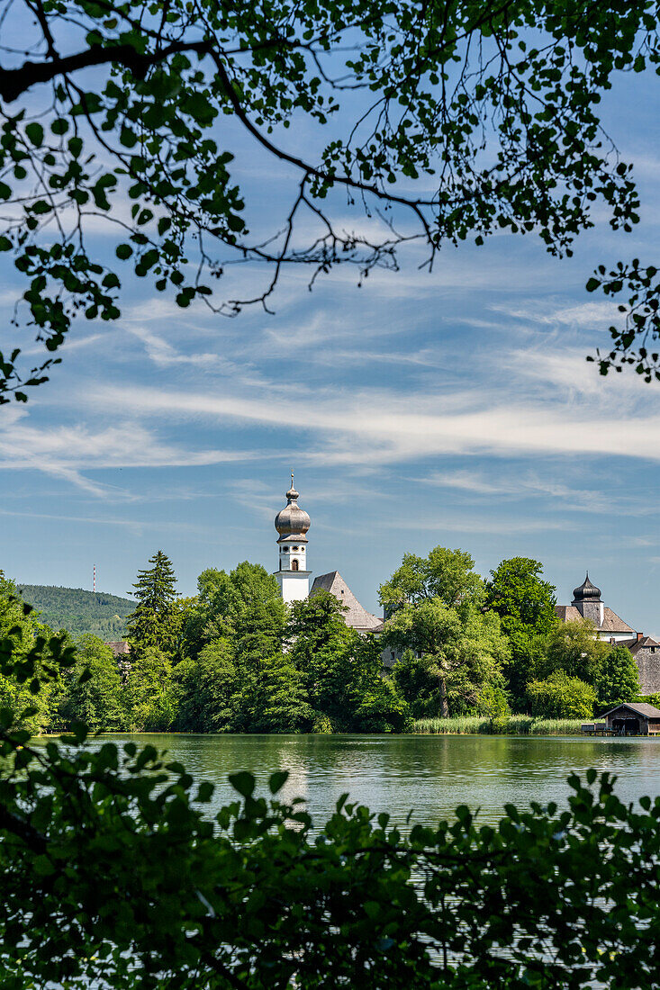 View in sunshine over the Höglwörther See to the monastery, Chiemgau, Bavaria, Germany