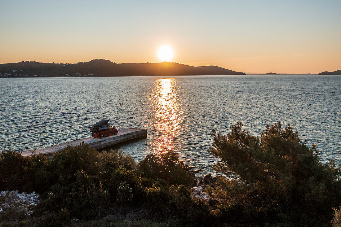 Road trip Croatia, with the camper on a jetty on the coast