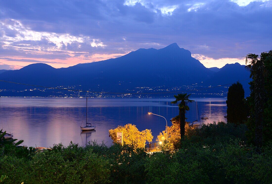 Evening view in Torri del Benaco to the west bank at Salo, east bank, Lake Garda, Veneto, Italy