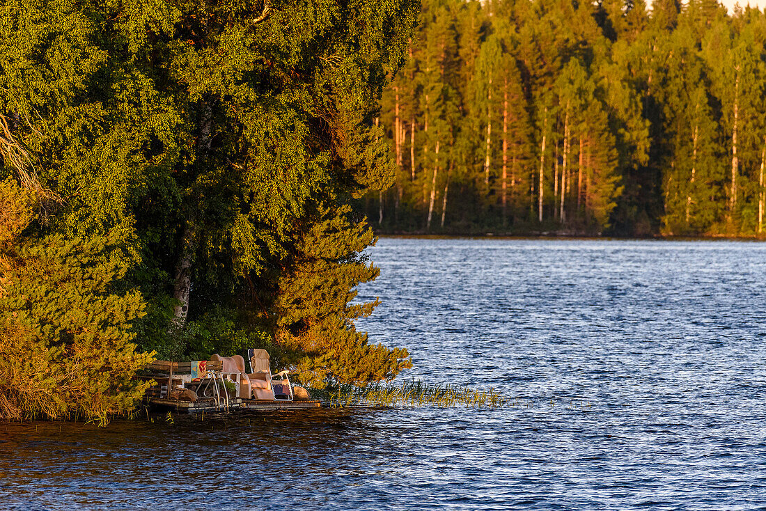 Campingstühle an einem See auf der finnischen Seenplatte, Finnland