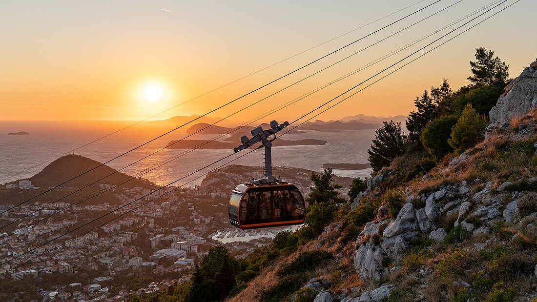 Gondola ride up Mount Srd during sunset in Dubrovnik, Dalmatia, Croatia.