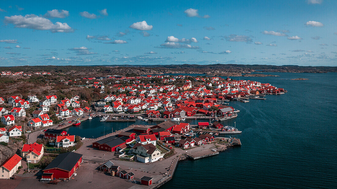 Coast and village of Mollösund on the archipelago island of Orust on the west coast of Sweden from above, sunshine on the day with a blue sky