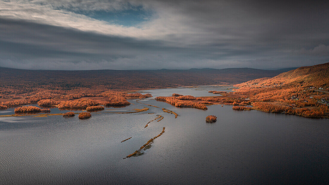 Lake with mountains and trees in autumn along the Wilderness Road in Lapland in Sweden from above