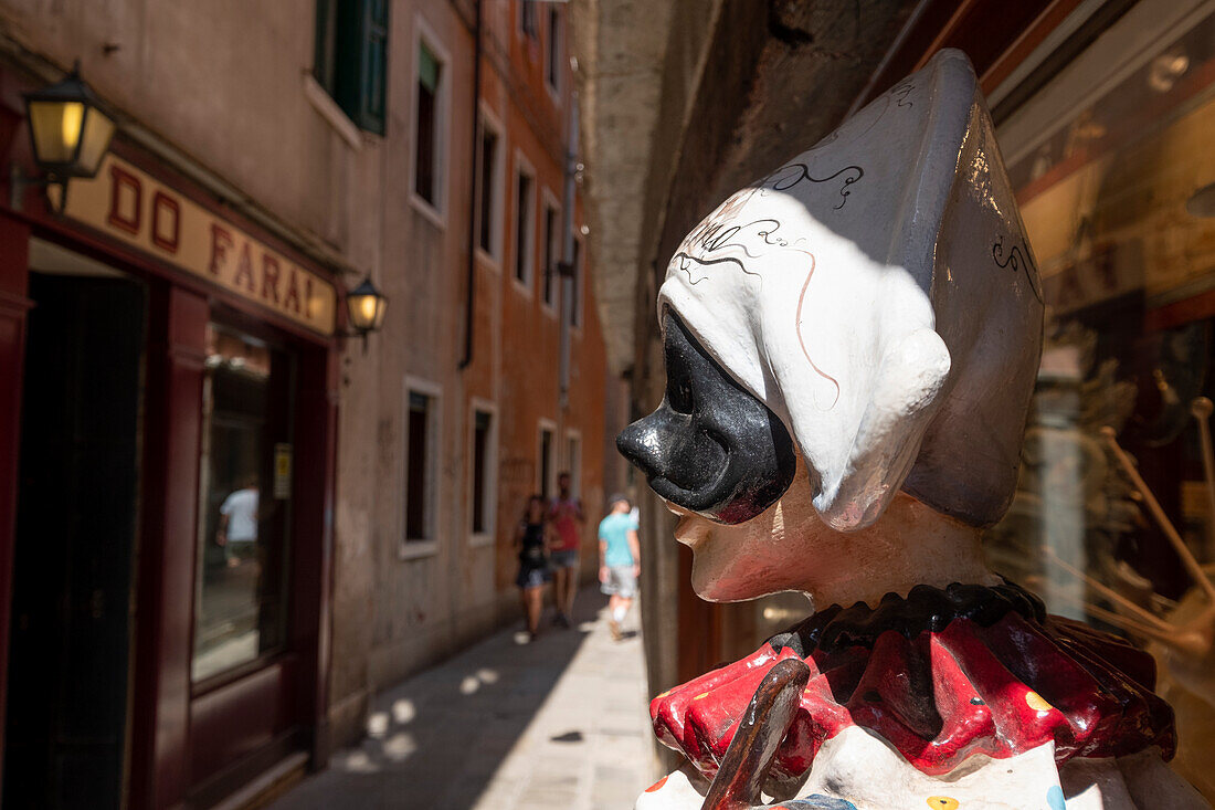 Detail view of Harlequin sculpture in Venice alley, Venice, Veneto, Italy, Europe