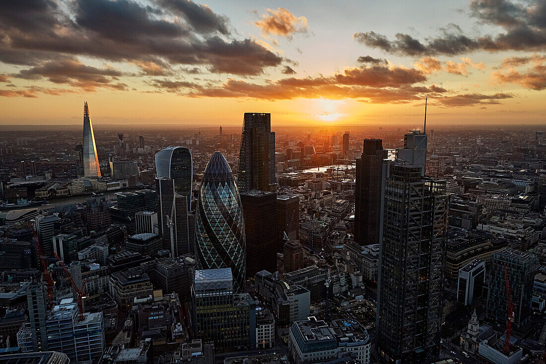 UK, London, High angle view of City of London skyscrapers at sunset