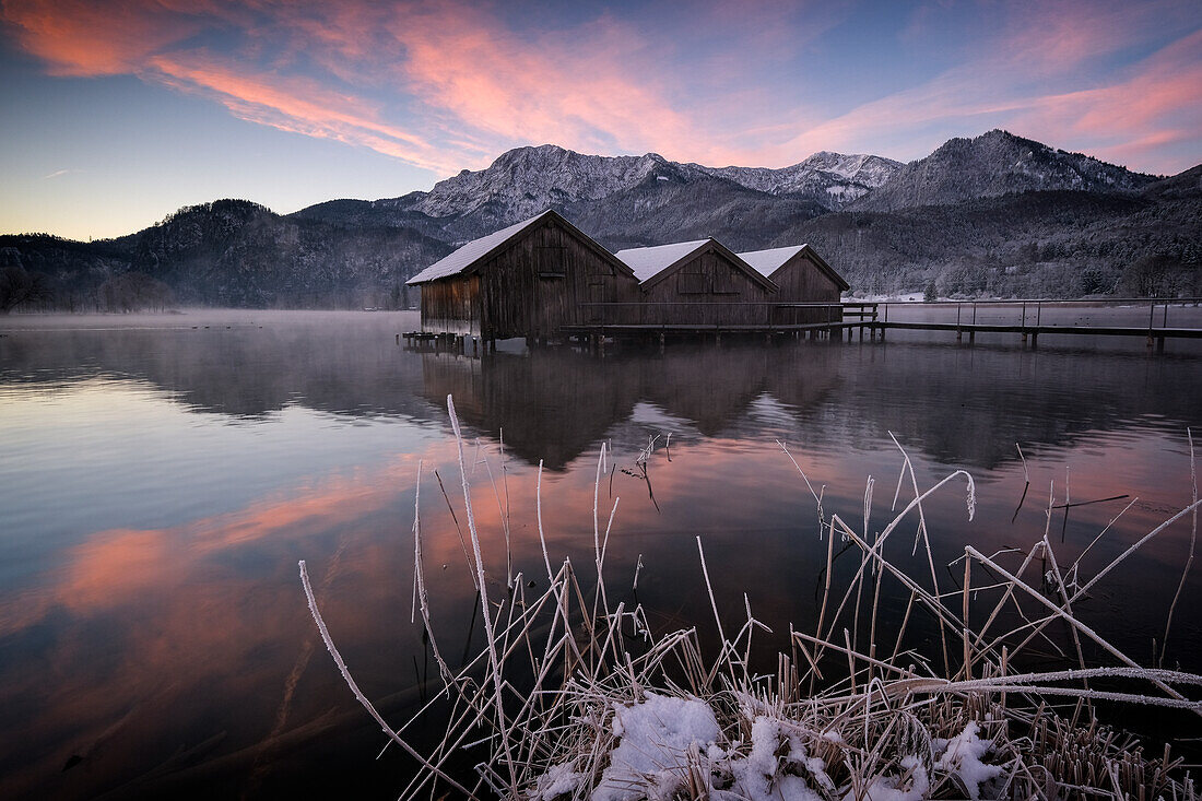 Wooden huts and footbridge on the Kochelsee at sunrise, in the foreground the icy lake shore, Schlehdorf, Bavaria, Germany, Europe