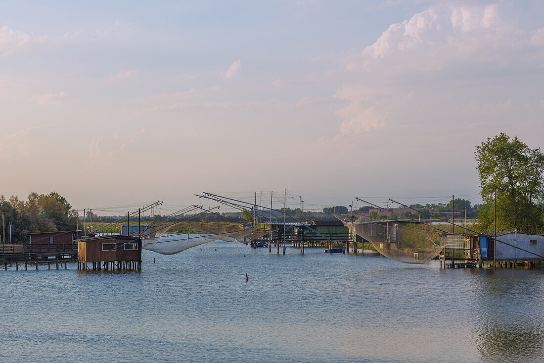 Comacchio, Porto Garibaldi, Canale Torre Rossa with fishermen's huts and outrigger nets