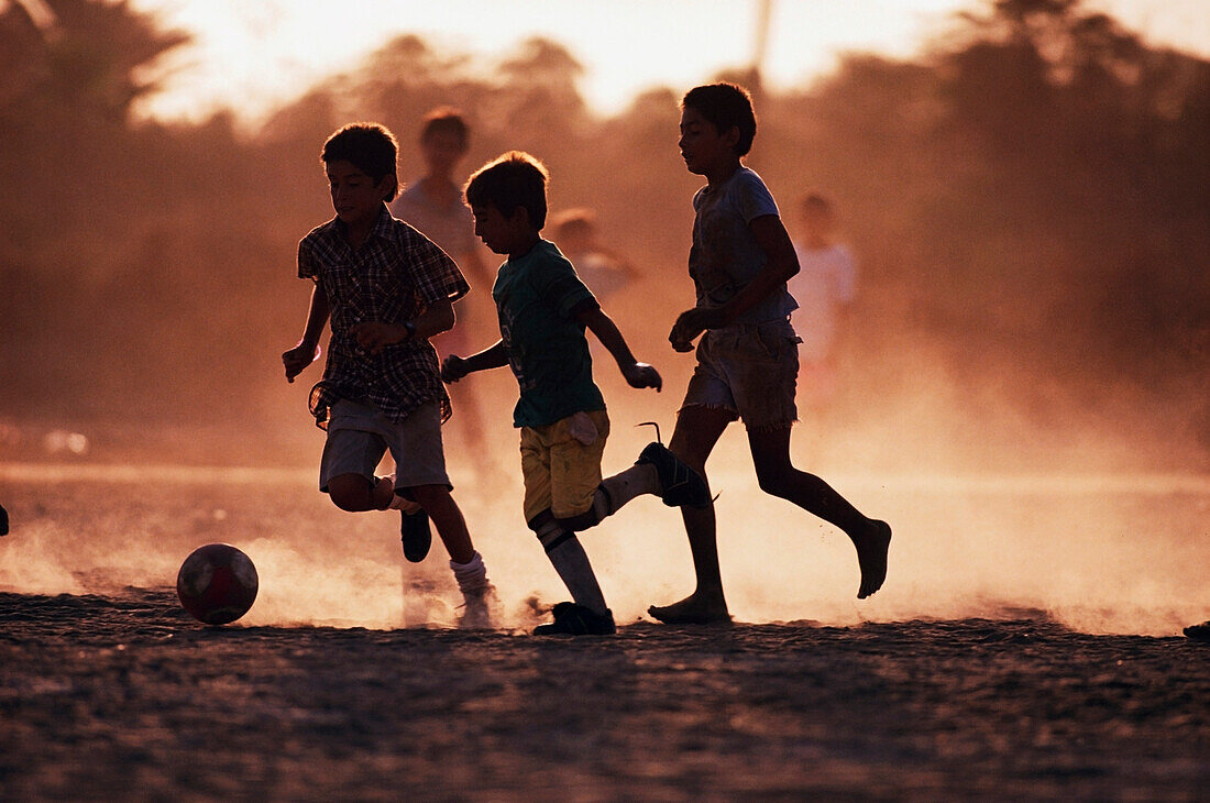 Boys playing soccer on the beach, Cabo San Lucas, Mexico