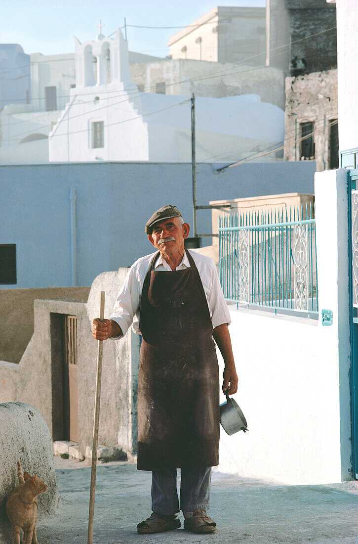 Senior man with a cane standing in a street, Santorini, Cyclades Islands, Greece