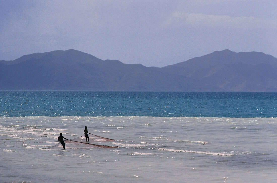 Men setting fishing nets in a lake, Lake Van, Turkey