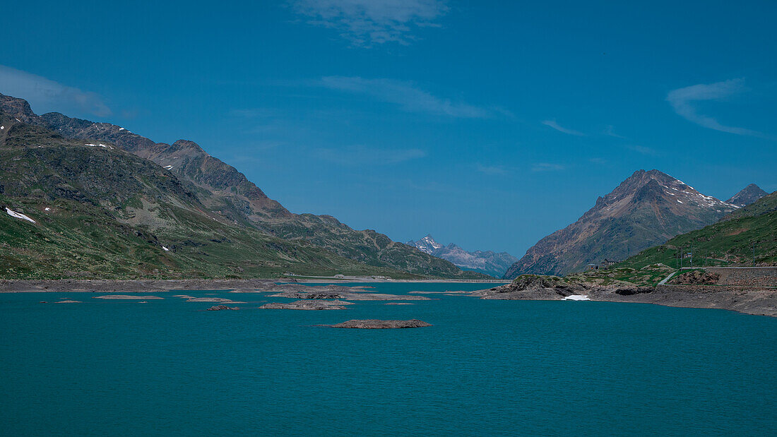 Landscape at the Lago Bianco reservoir at the Bernina Pass in the sun