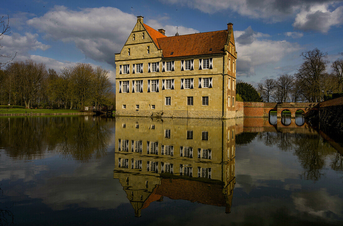 Manor house of the moated castle Burg Hülshoff in Havixbeck in spring, Muensterland, North Rhine-Westphalia, Germany
