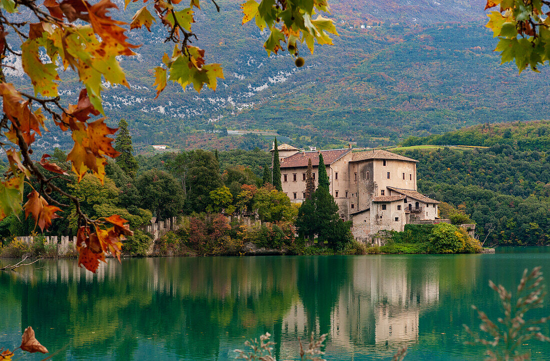 Lake Toblino with the castle in autumnal guise. It is a small Alpine lake in the province of Trento (Trentino-Alto Adige) and has been declared a Biotope for its naturalistic qualities. Location used for film production. Italy