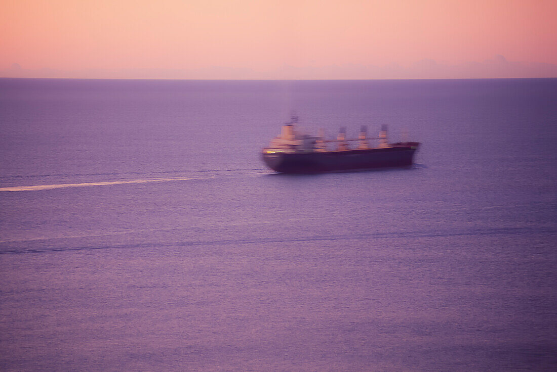 Cargo Ship at sea at dawn