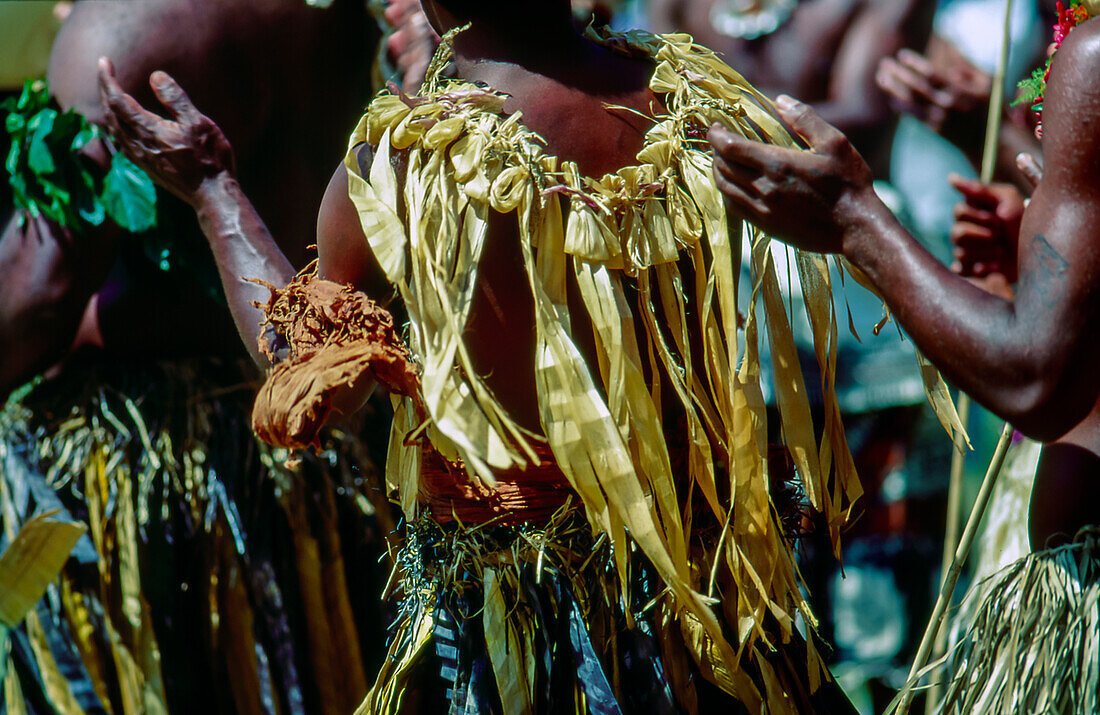 Native Fijian men dressed in traditional dress performing and dancing