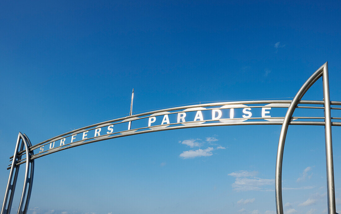 Metal arch showing the words Surfers Paradise against blue sky