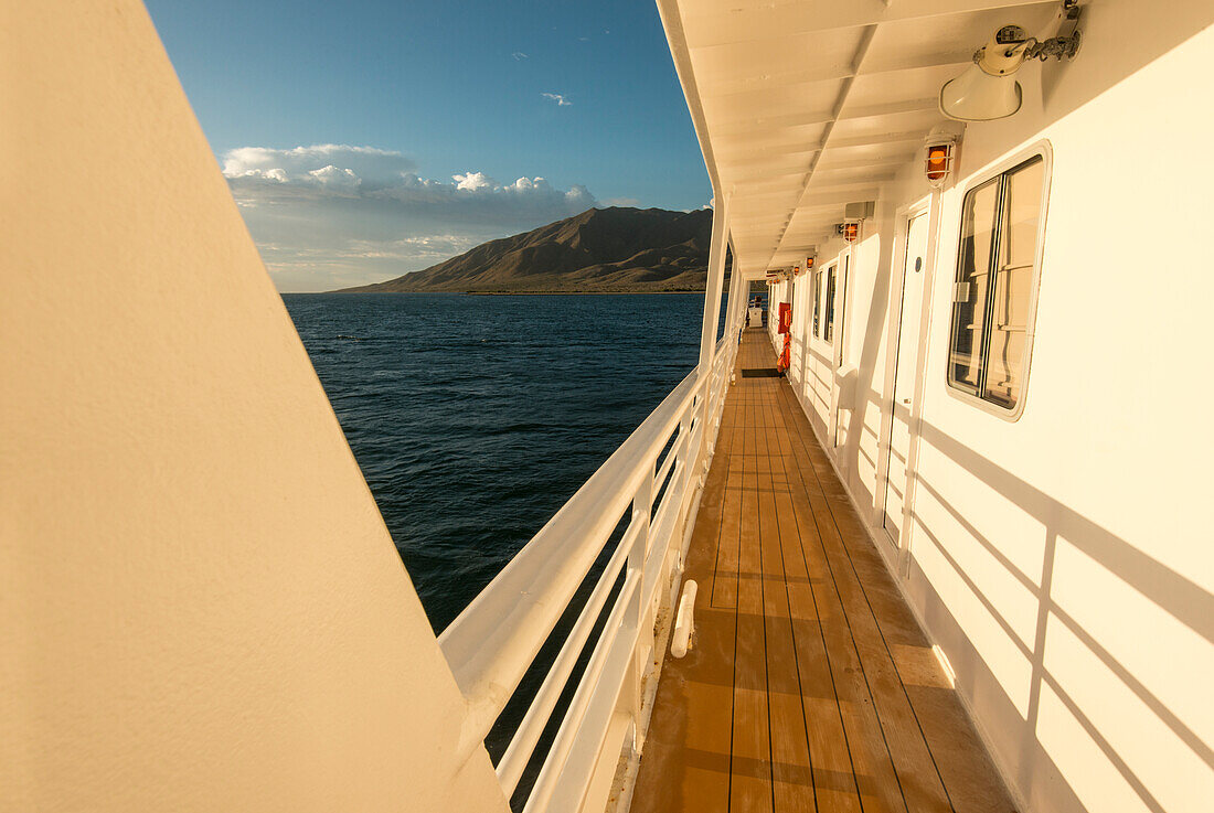 The deck of the National Geographic Sea Lion in sunrise light with Magdalena Island in the background, Baja California Sur