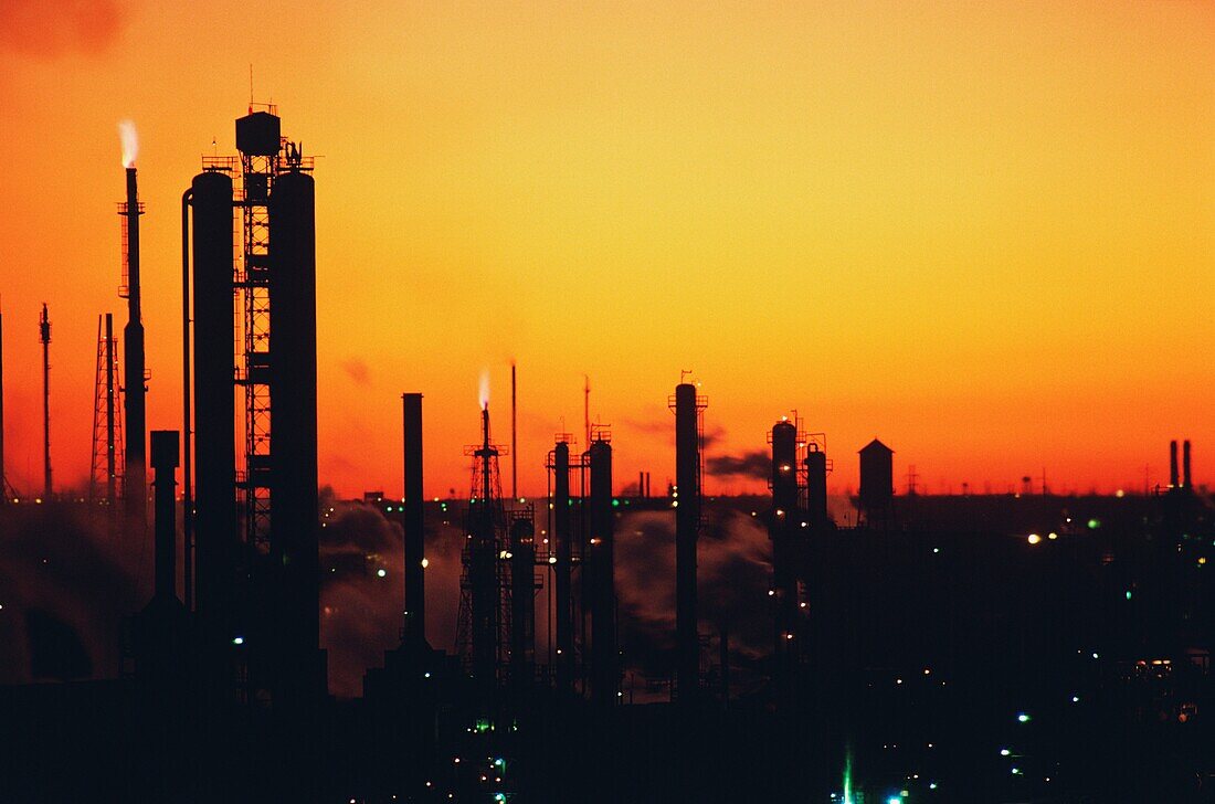Silhouette of an oil refinery at sunset, Texas, USA