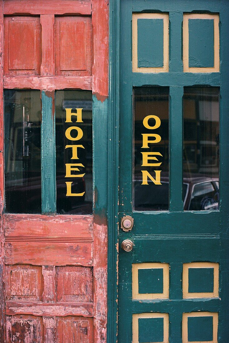 Old western hotel doors painted with the words Hotel and Open, Telluride, San Miguel County, Colorado, USA