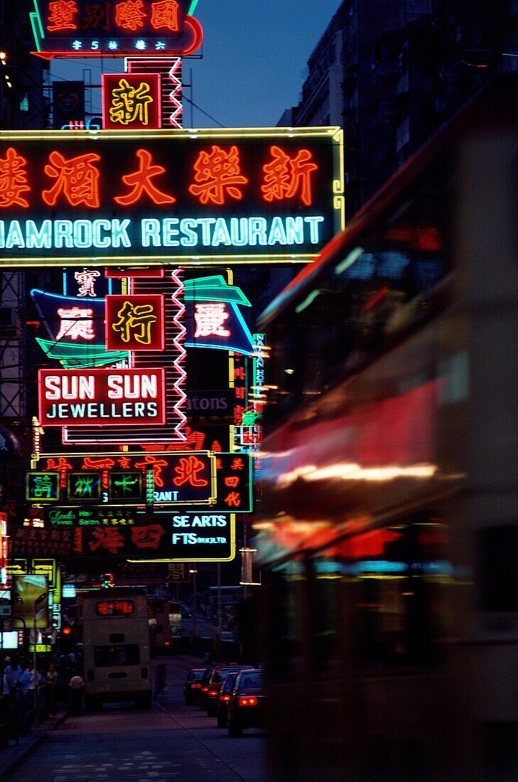 Neon signs of restaurants and stores on Nathan Road at night, Hong Kong