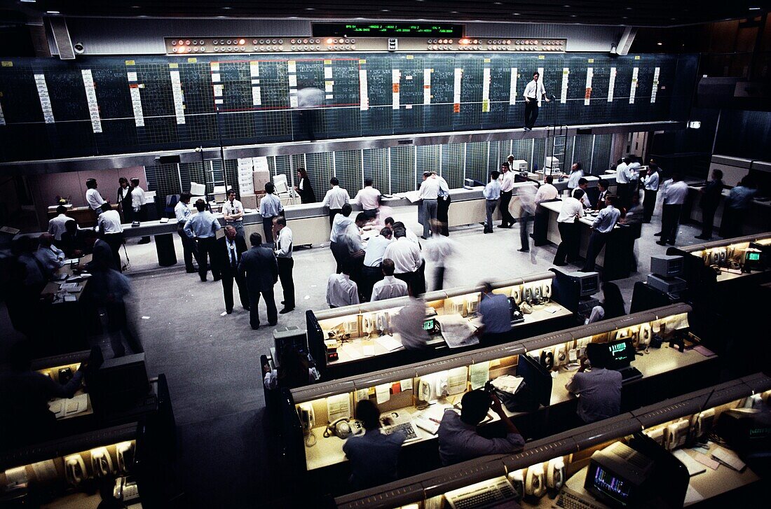 Traders working in the open floor of a stock trading center, Sydney, New South Wales, Australia