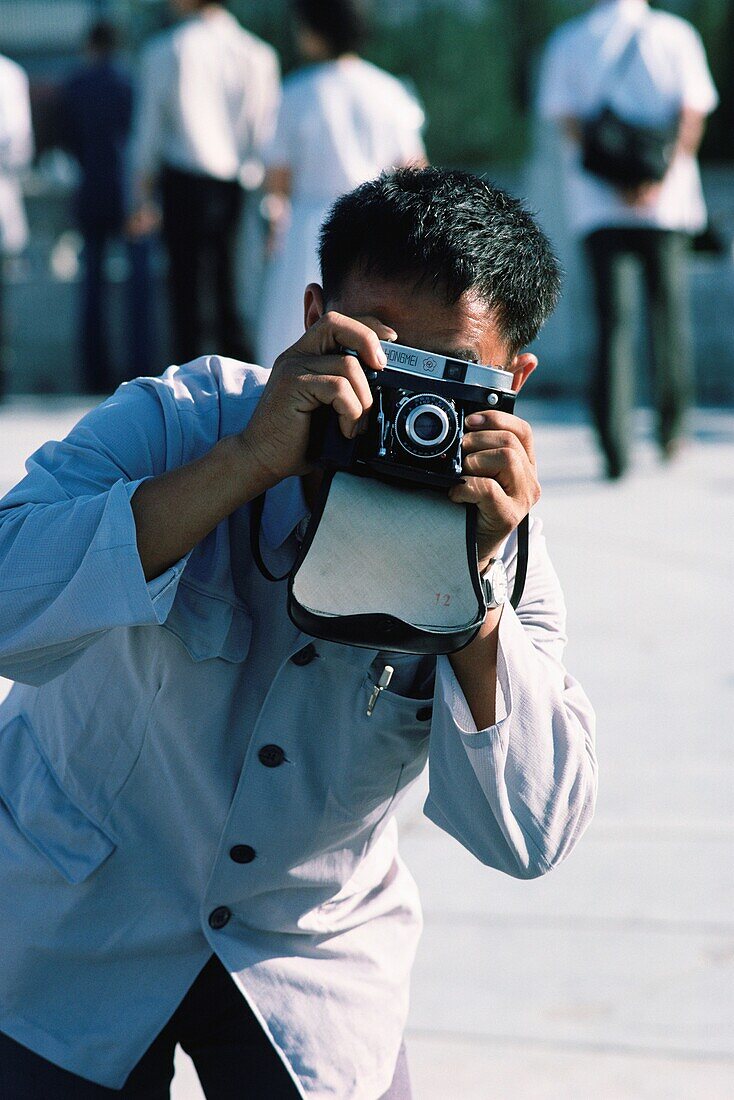 Man taking a picture with a camera, Beijing, China