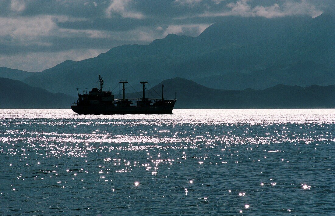 Ship in the sea with mountains in background, Hong Kong