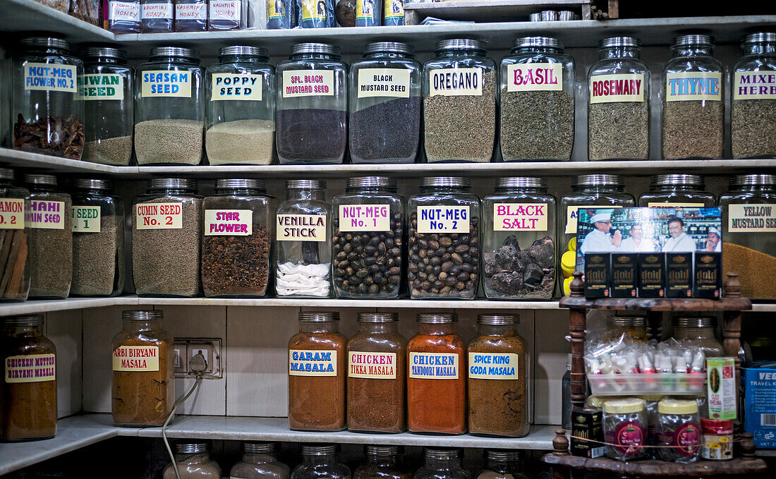 Row of glass jars filled with herbs and spices in Mumbai shop