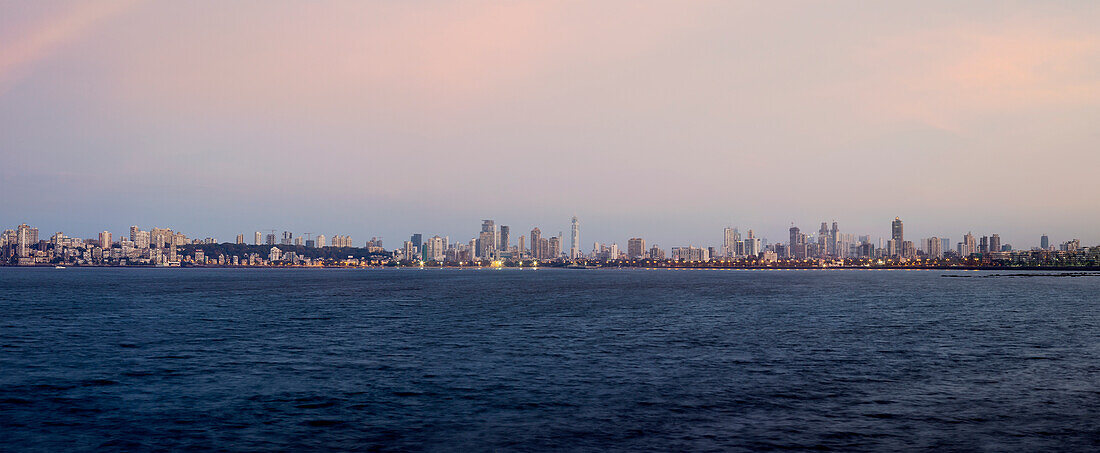 Looking across water at Mumbai city skyline
