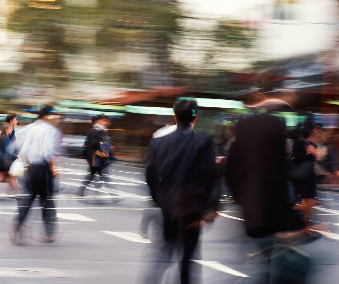 People crossing intersection in city