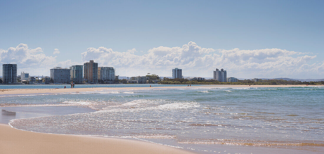 Looking across the water from Maroochy River at apartment buildings on the beach at Maroochydore