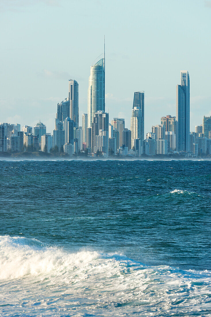 Looking across waves at Kirra Beach to city skyline of Surfers Paradise