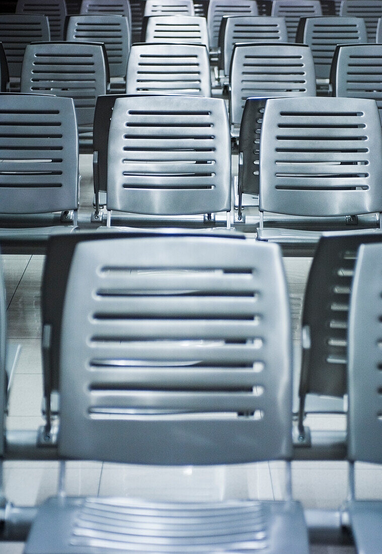 Rows of white plastic empty seats