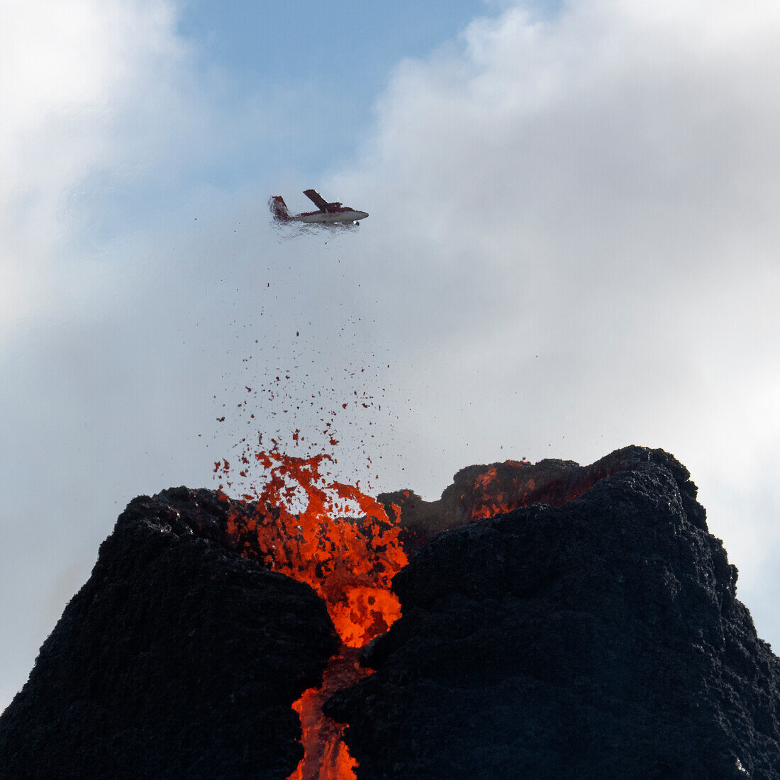 Reykjanes Peninsula, Iceland - March 23rd 2021: Volcanic eruption Reykjanes Peninsula Iceland, with a plane in the background. Fagradalsfjall Volcano, Geldingadalir Eruption