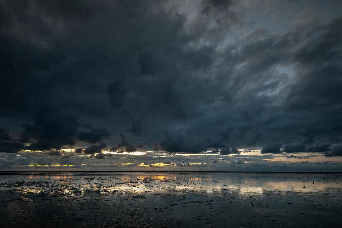 Sunset at the Wadden Sea under rain clouds at the North Sea, Schillig, Wangerland, Friesland, Lower Saxony, Germany, Europe
