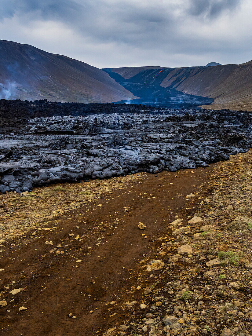 Road being covered by fresh lava from Fagradalsfjall Volcano, Iceland